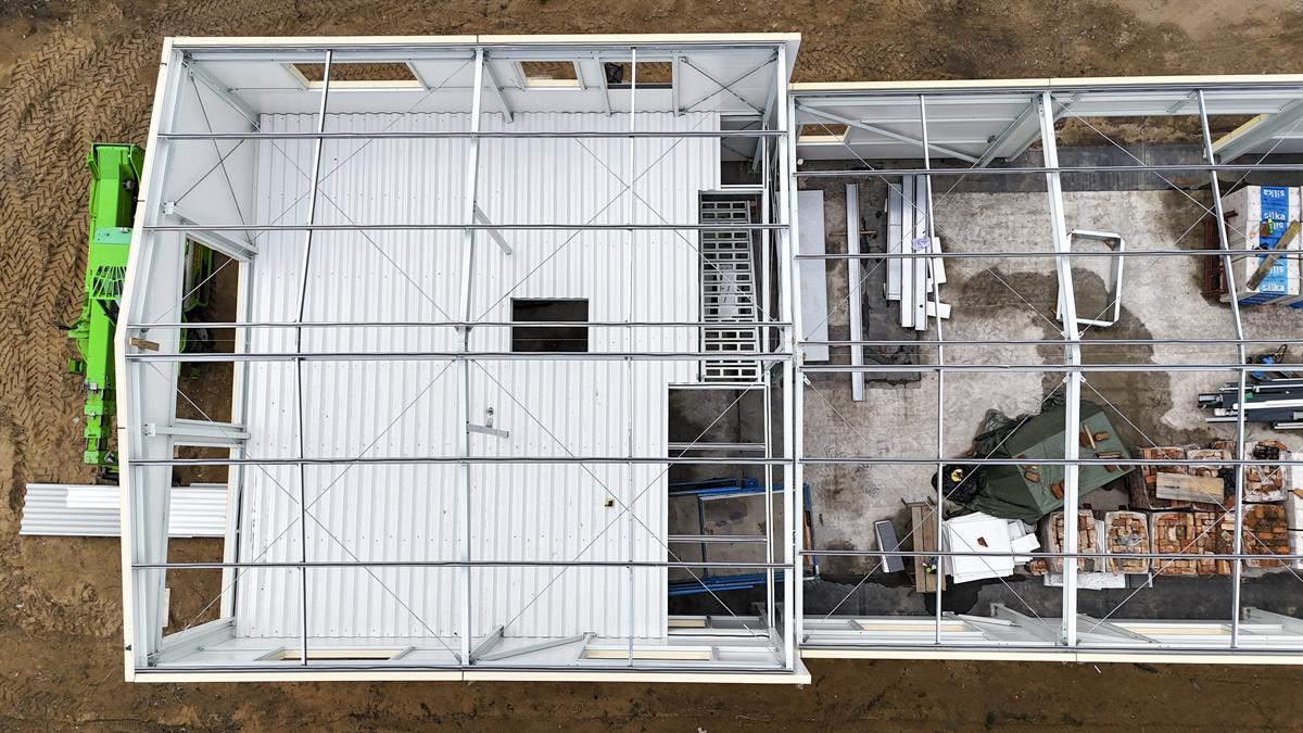 Senkrechte Drohnenaufnahme einer Gewerbehalle im Rohbau mit Stahlkonstruktion